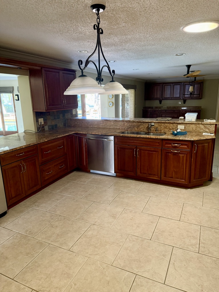 Existing kitchen with dark wood cabinetry prior to renovation in Venetian Isles, St. Petersburg, Florida